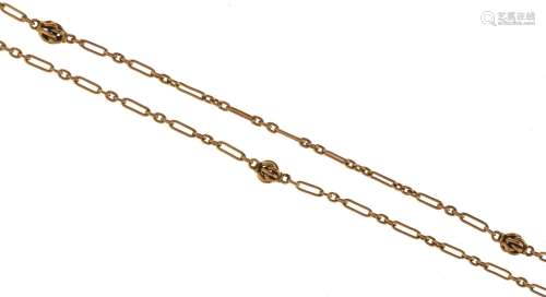 A gold long chain, early 20th c, of long and short links wit...