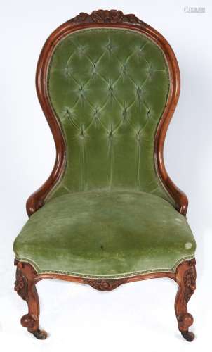 A Victorian walnut nursing chair, c1870, the top rail carved...