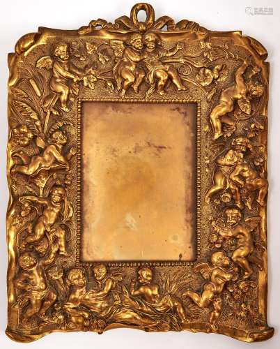 A gilt brass photo frame decorated with cherubs, late 19th c...