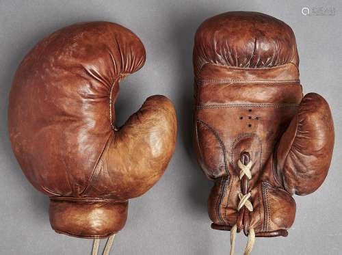 Boxing. An antique pair of leather boxing gloves, early 20th...