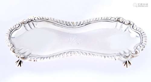 A George III gadrooned silver snuffers tray, on claw and bal...