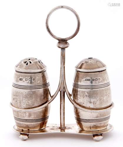A George V silver cruet frame and pair of barrel shaped cond...