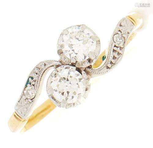 A diamond crossover ring, in gold marked 18ct plat, 9g, size...