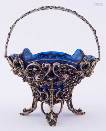 A Victorian cast silver sugar basket, of ogee shape with swi...
