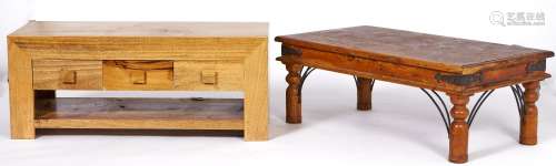A modernist hardwood coffee table, fitted with three drawers...
