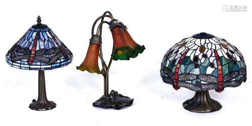 Two Tiffany style table lamps and another, similar, in the f...