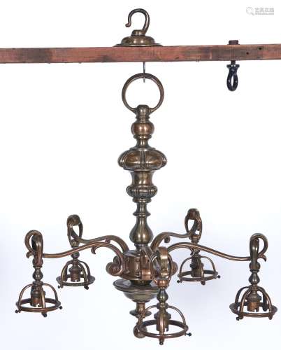 A brass chandelier, c1920, of five lights with mushroom knop...