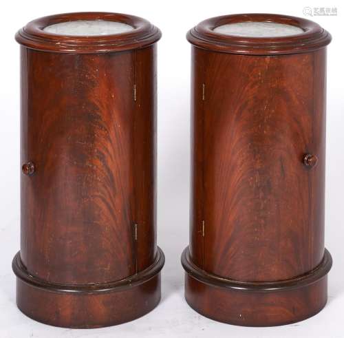 A pair of cylindrical mahogany pot cupboards, 20th c, in Vic...