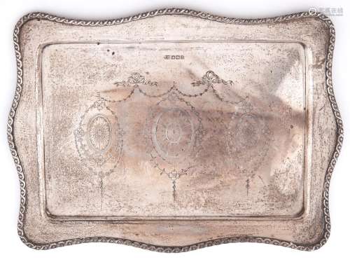 A George V serpentine silver dressing table tray, engraved w...