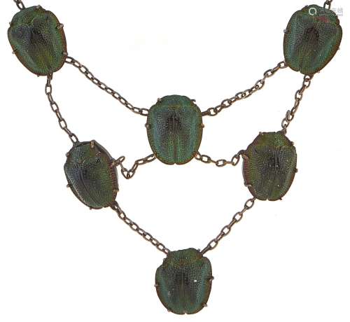 An Egyptian scarab beetle necklet, c1920, in silver coloured...