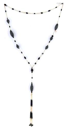 A 1920's necklace of black and white glass beads with large ...