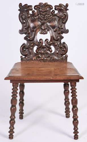 A Victorian carved walnut hall chair, with boarded seat on b...