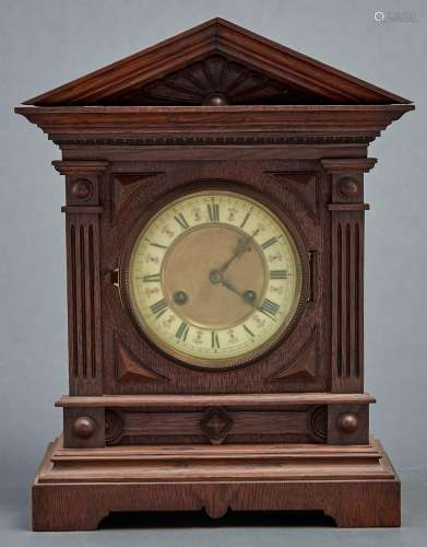A late Victorian oak mantel clock, c1890, the flared archite...
