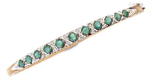 A 9ct gold diamond and emerald bangle, 9.9g