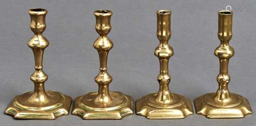 Two pairs of George II brass candlesticks, mid 18th c, with ...