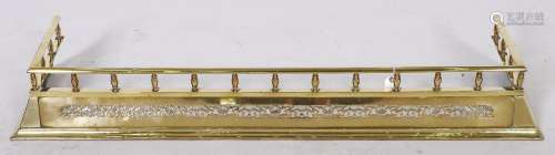An Edwardian pierced brass fender, c1905, splay fronted bene...