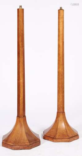 A pair of art deco stained walnut standard lamps, mid 20th c...