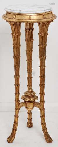 A reproduction gold painted tripod torchere, third quarter 2...