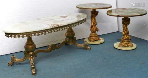 Two similar giltmetal and onyx putto figural pedestal tables...