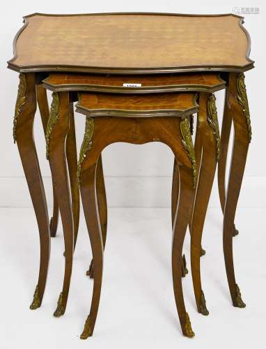 A nest of three kingwood and mahogany tables, 20th c, in Lou...