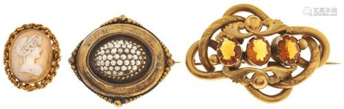 A cameo brooch, in gold and two Victorian giltmetal brooches...