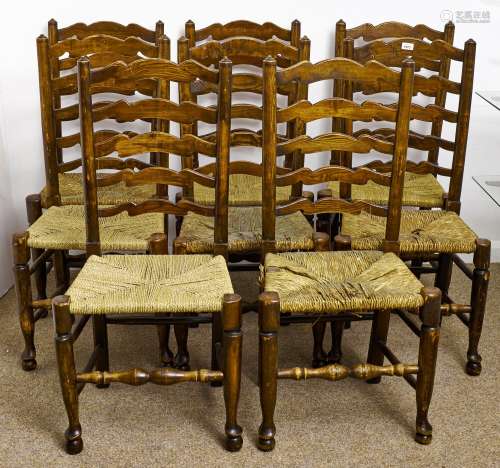 Eight stained ash ladder back chairs, early 20th c, rush sea...