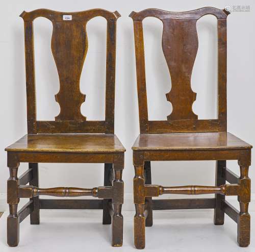 A pair of George III oak chairs, 18th c, with vase profile s...