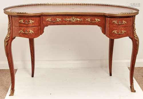 A French kidney shaped tulipwood and kingwood writing table,...