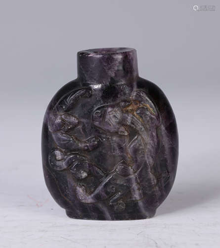 A Carved Amethyst Chi-Dragon Snuff Bottle