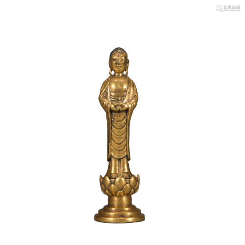 A gilt-bronze standing buddha