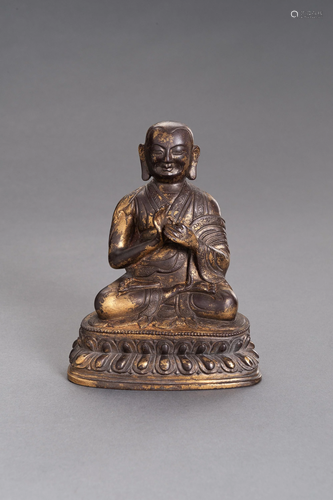 A BRONZE PORTAIT FIGURE OF A LAMA