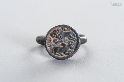 A BRONZE INTAGLIO RING WITH A HUNTING LION