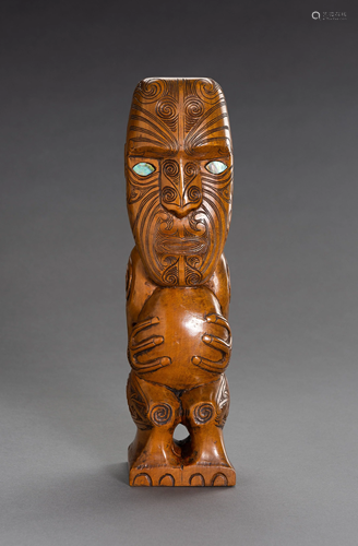 A CARVED MAORI TIKI WOOD FIGURE