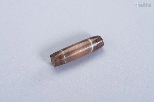 AN OLD TUBULAR 'CHUNG DZI' BROWNISH AGATE BEAD