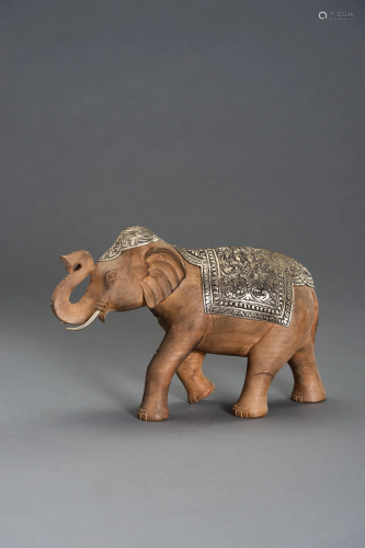 A WOOD AND SILVERED METAL CAPARISONED ELEPHANT