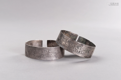 A PAIR OF SILVER BANGLES