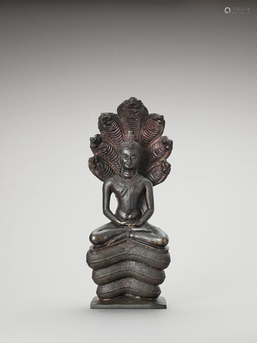 A KHMER STYLE BRONZE OF BUDDHA MUCHALINDA