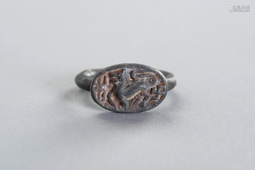 A BRONZE INTAGLIO RING DEPICTING A MYTHICAL BEAST