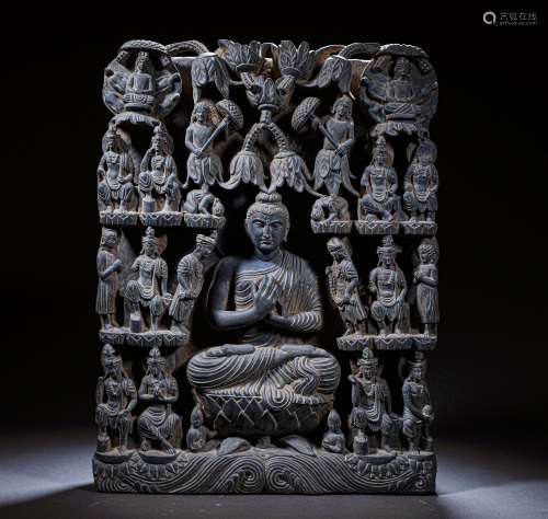 A GREY STONE CARVING OF BUDDHA STATUE