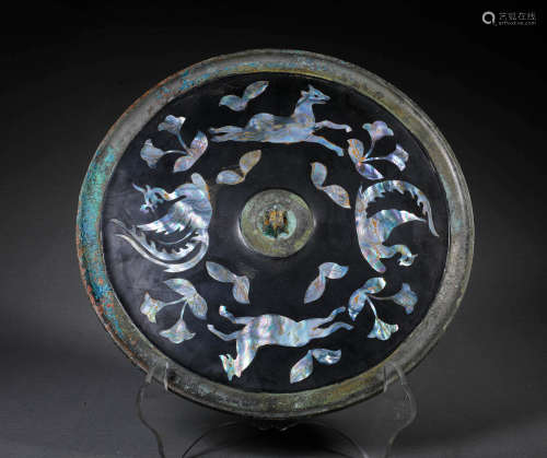 A BRONZE MIRROR WITH SEA SHELL INLAYS