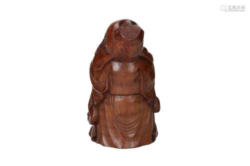 A sculpture carved from bamboo, depicting the god of fortune...