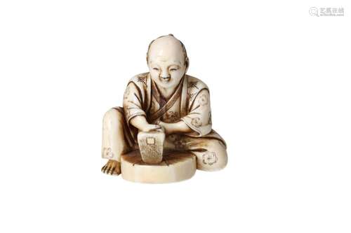 An ivory netsuke depicting a carpenter with a drawbar workin...