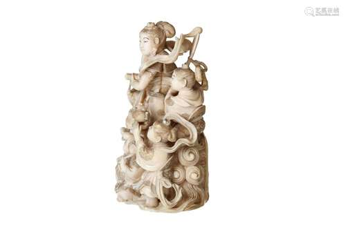 An ivory okimono depicting a group with a goddess and three ...