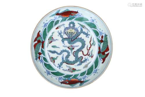 A doucai porcelain deep saucer, decorated with fish and a dr...