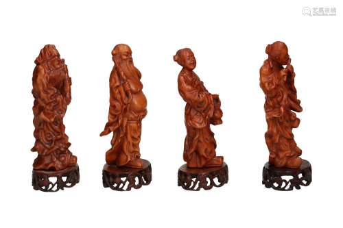 Lot of four carved boxwood figures on a base, depicting four...
