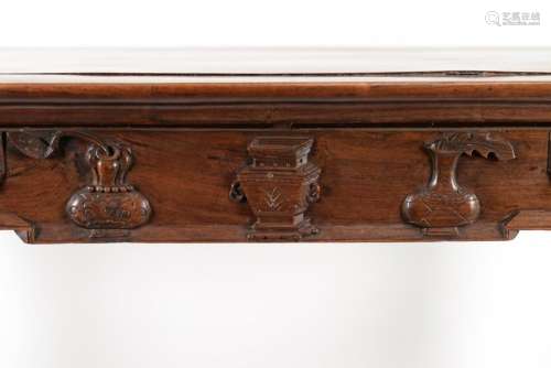 A rosewood side table with a carved decoration of antiquitie...