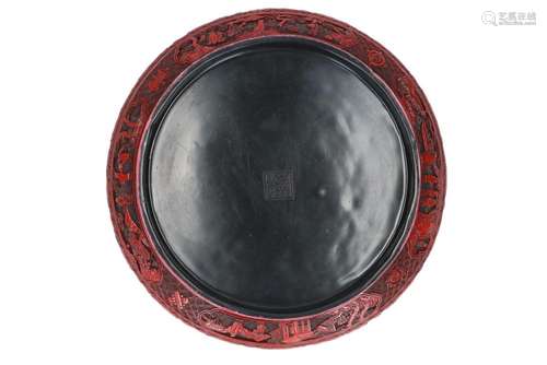 A round cinnabar lidded box, with carved decor of figures. M...