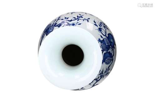 A blue and white porcelain vase decorated with pomegranates....