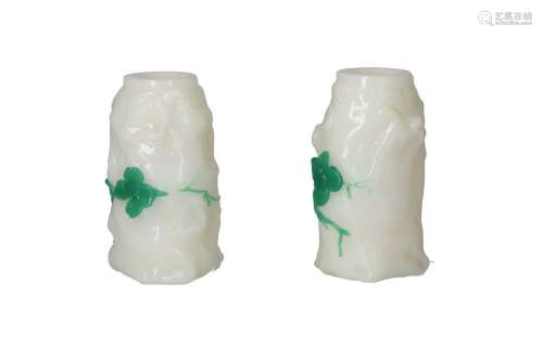 A pair of white glass stem vases, decorated with a green plu...