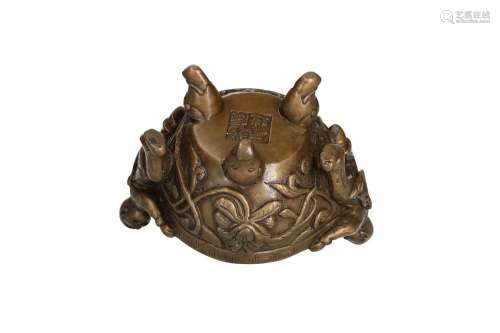 A bronze censer, decorated with flowers and two cheerful fig...